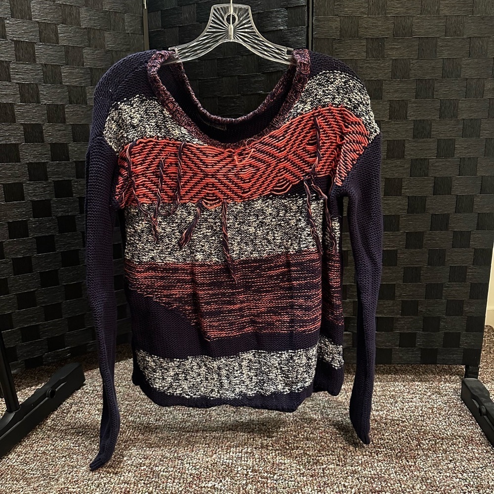 Small orange, white, and blue sweater